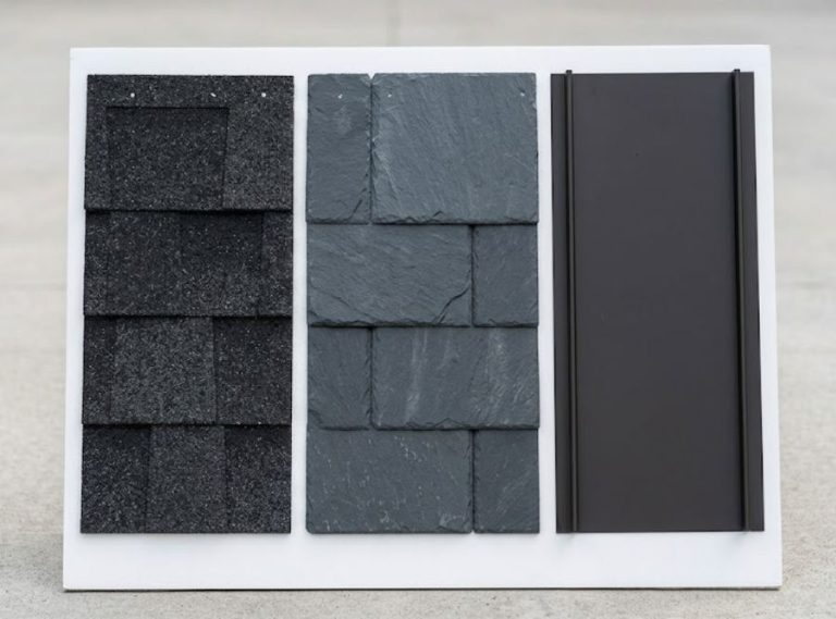 Premium roofing sample board featuring architectural shingles, designer slate, and dark standing seam metal.