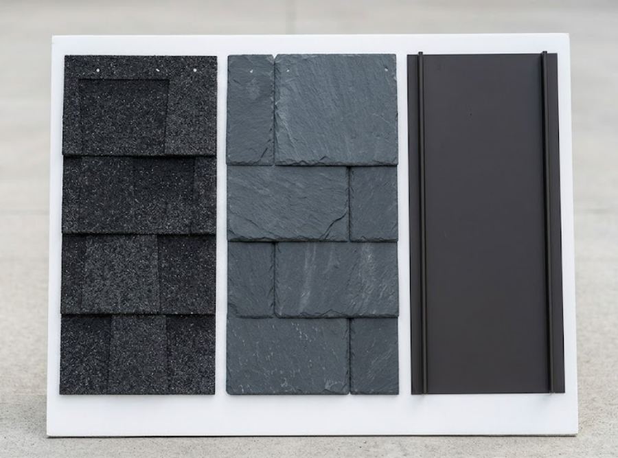 Premium roofing sample board featuring architectural shingles, designer slate, and dark standing seam metal.